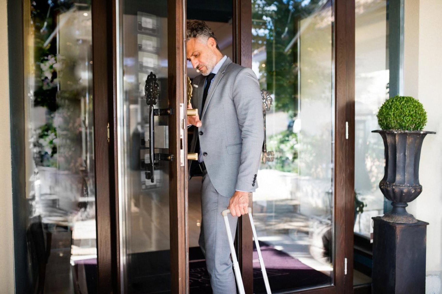Business traveler arriving at a US hotel after skipping the front desk with a mobile app