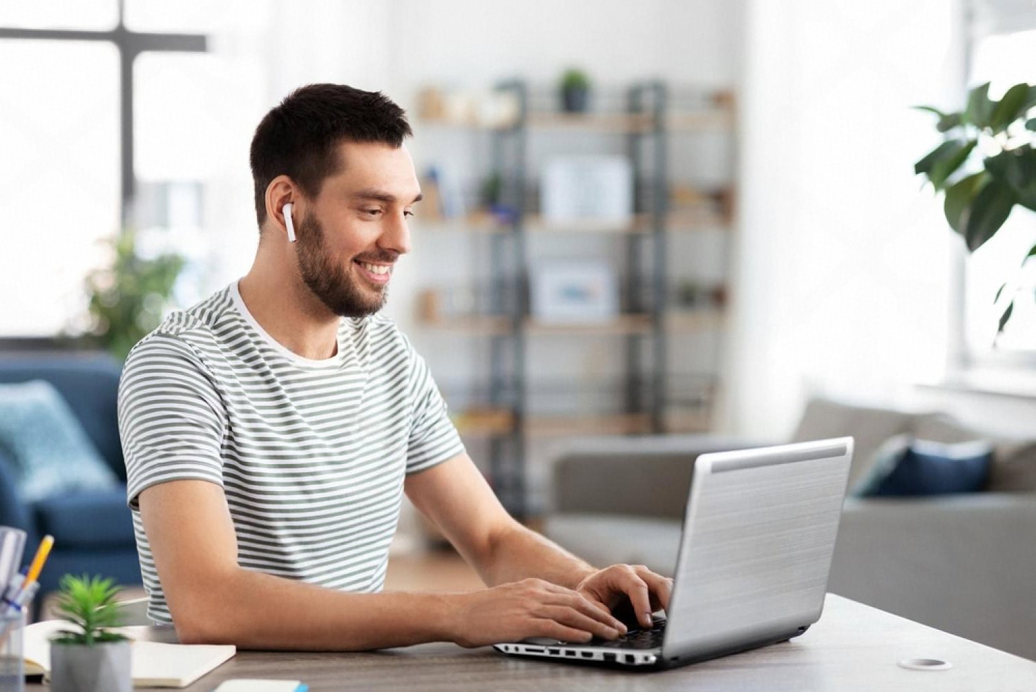 Man comparing domain registrars in the UAE on a laptop at home