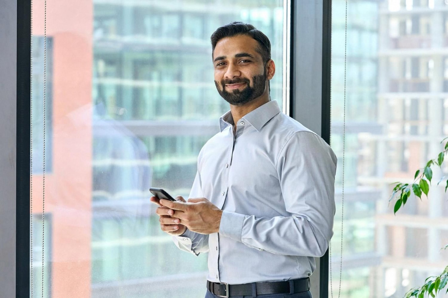 Professional legal consultant in a UAE office reviewing a medical malpractice case on a mobile device