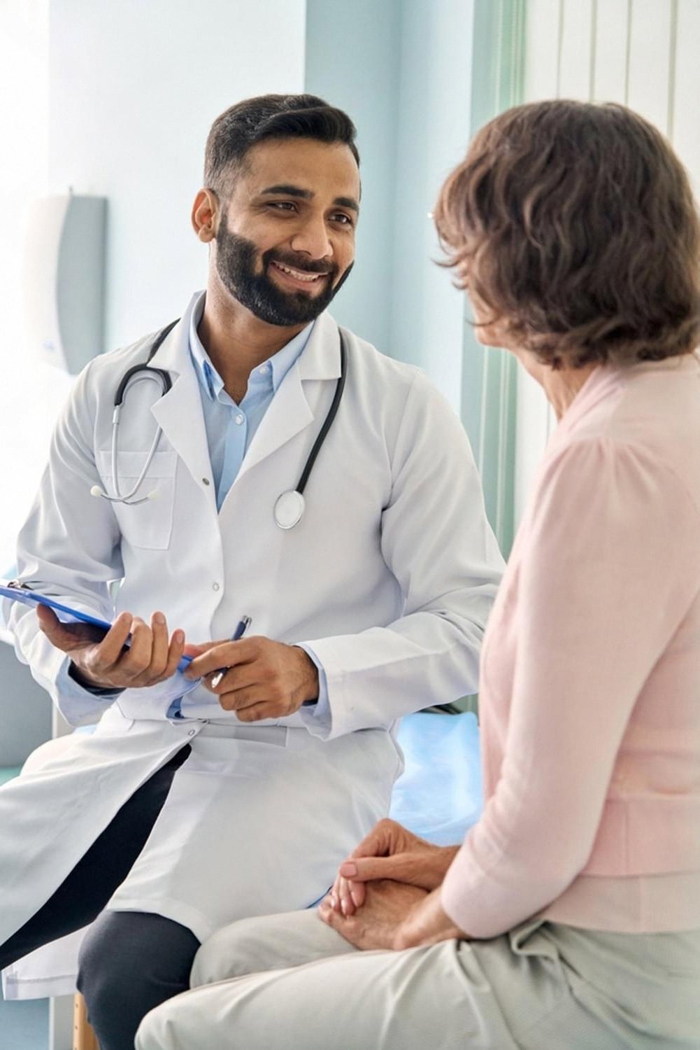 Doctor consulting with a patient about her medical insurance plan in a Dubai clinic